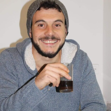 Avi Fenesh smiling at a table